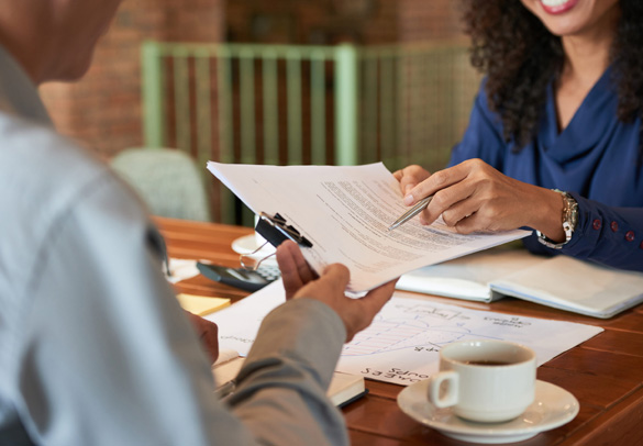 Business partners signing a contract after a successful vendor selection